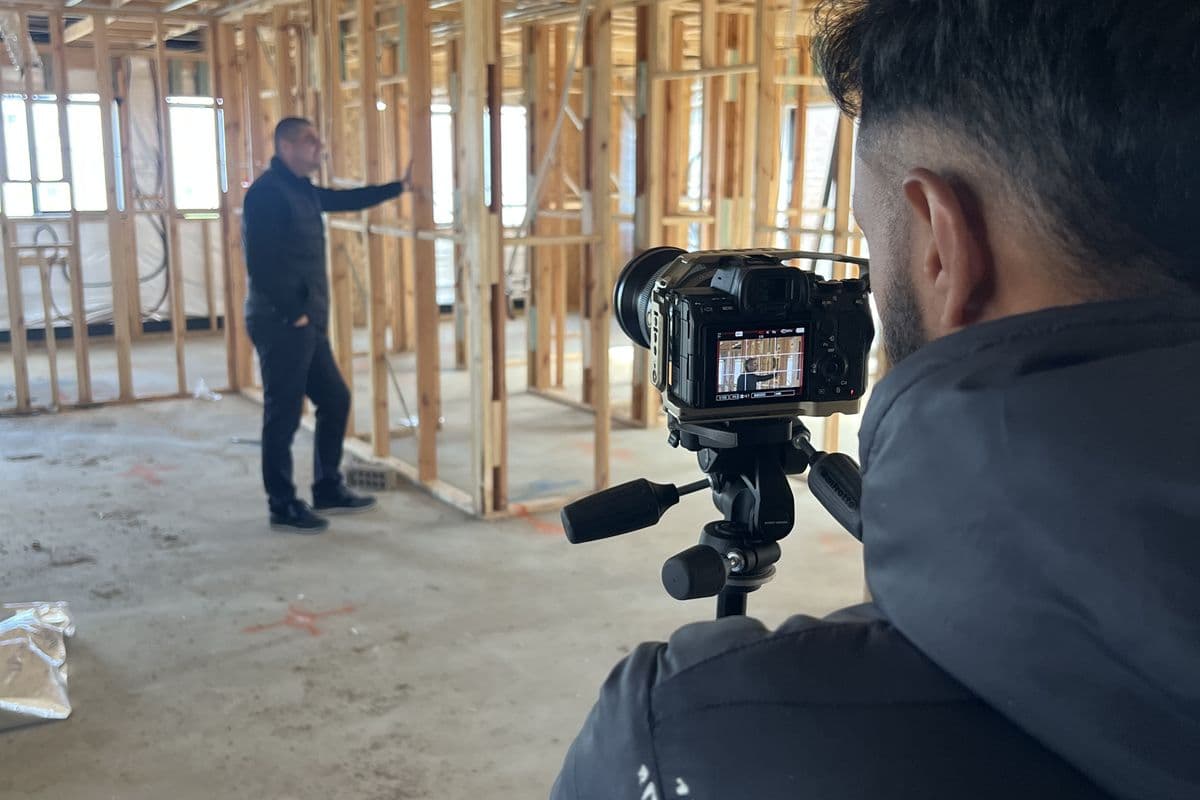Filming a client's ad on site at frame stage